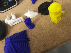 Various 3D printed models on top of a table, serving as just a few examples of what can be done with Open Source Maker Labs.