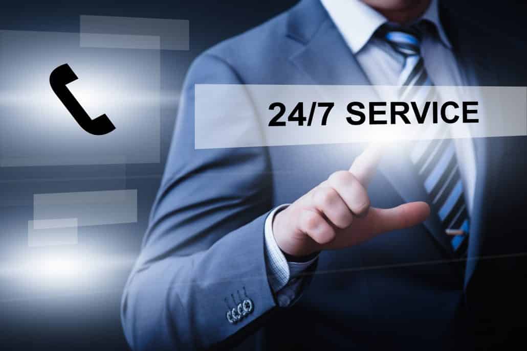 A businessman hovering his finger over a floating text button that says "24/7 Service".