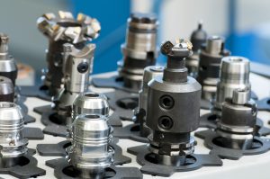 A close up of various machine tool heads not currently in use by a machine.