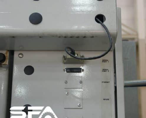 A CNC machine with a serial cable leading from Serial Port 1 to a USB Connect installed inside the machine.