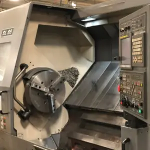 A shot of the side of a metal cutting machine, showing the leftover metal chippings and debris.