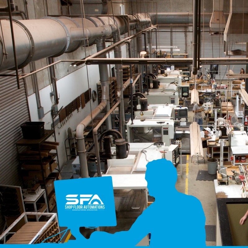 An upper view of a shop floor with various CNC machines in view and several employees hard at work. There is an overlaid silhouette of someone at a desktop computer with the SFA logo on it.