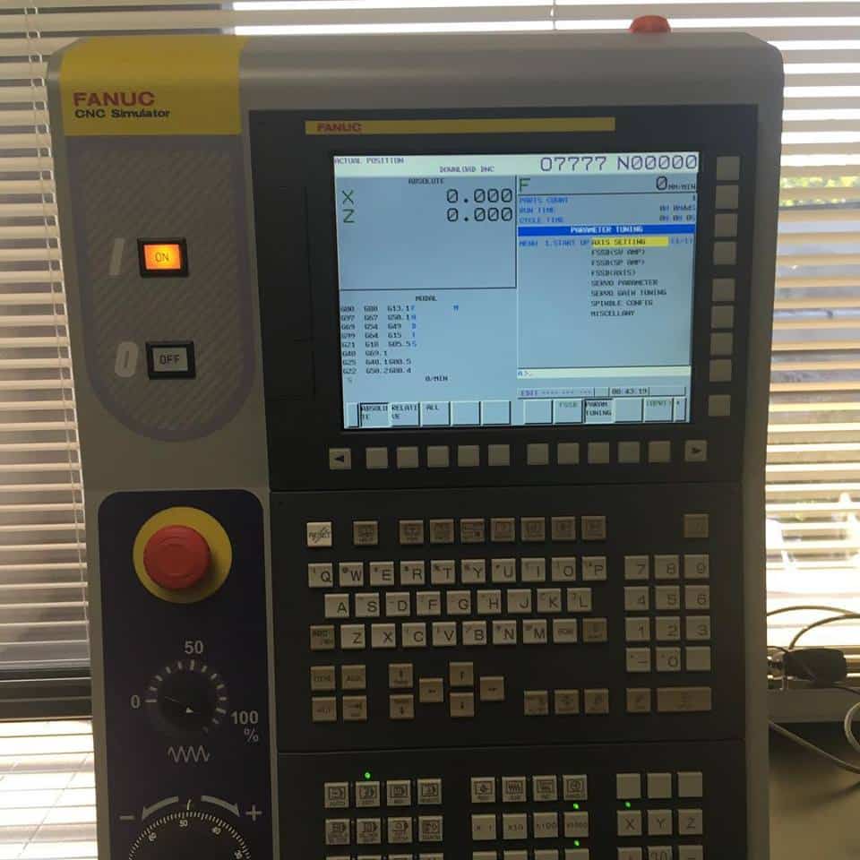 A front view of a Fanuc CNC controller, which is being monitored with machine monitoring software.