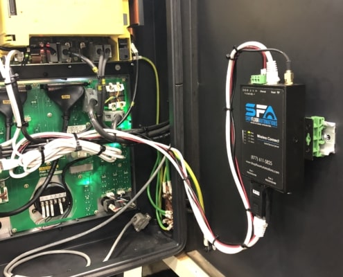 A Wireless Connect unit is mounted on the inside of a Doosan machine to provide wireless network capability.