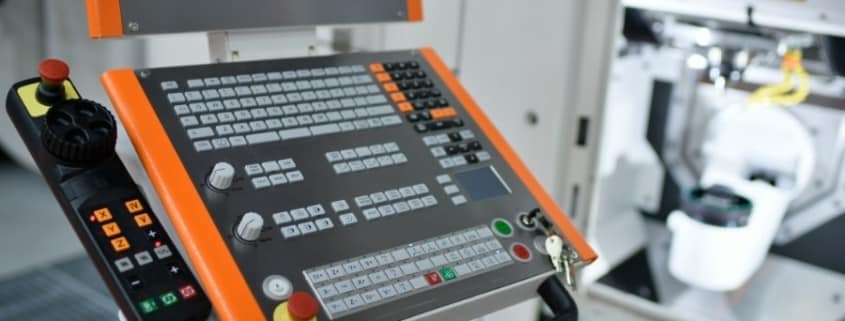 A CNC machine controller powered on and receiving code wirelessly through a CNC network.