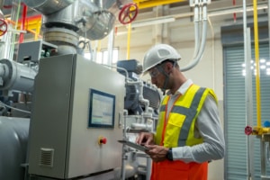 A machinist assesses the status and progress of a machine by using machine monitoring software, which can alert employees of an issue well before it becomes a costly problem.