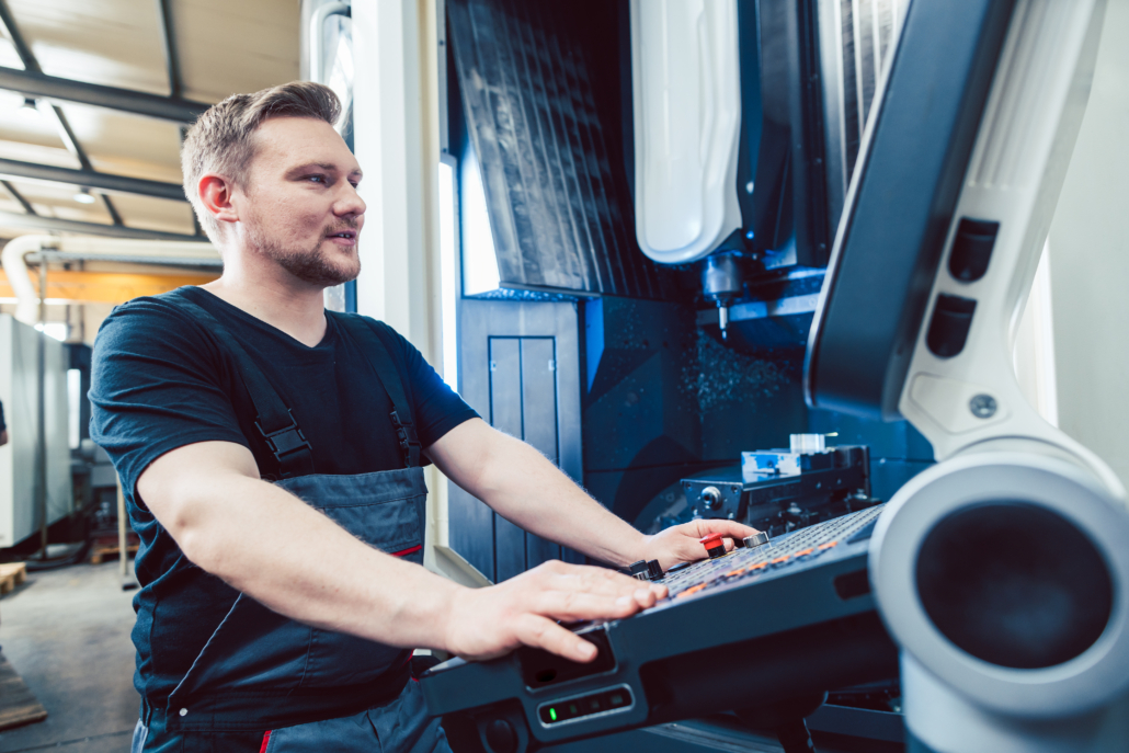 A machinist working with a machine that is running DNC software, removing the need for physical drives and saving time between jobs.