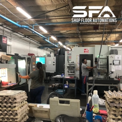 Machine techs working with CNC machines at R & D Manco.